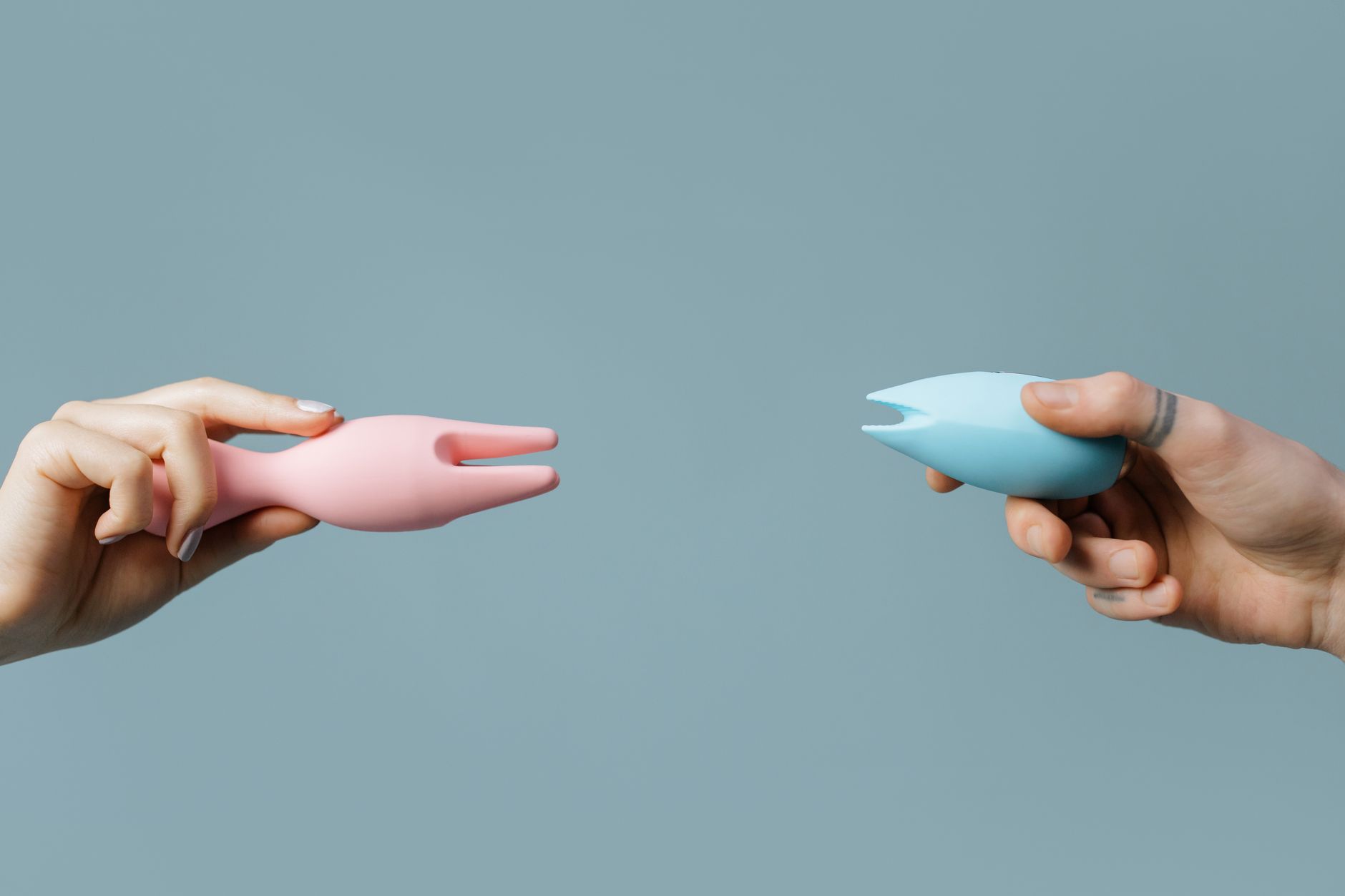 A hand holding a fresh lemon against a bright yellow background, symbolizing the Lem vibrator.
