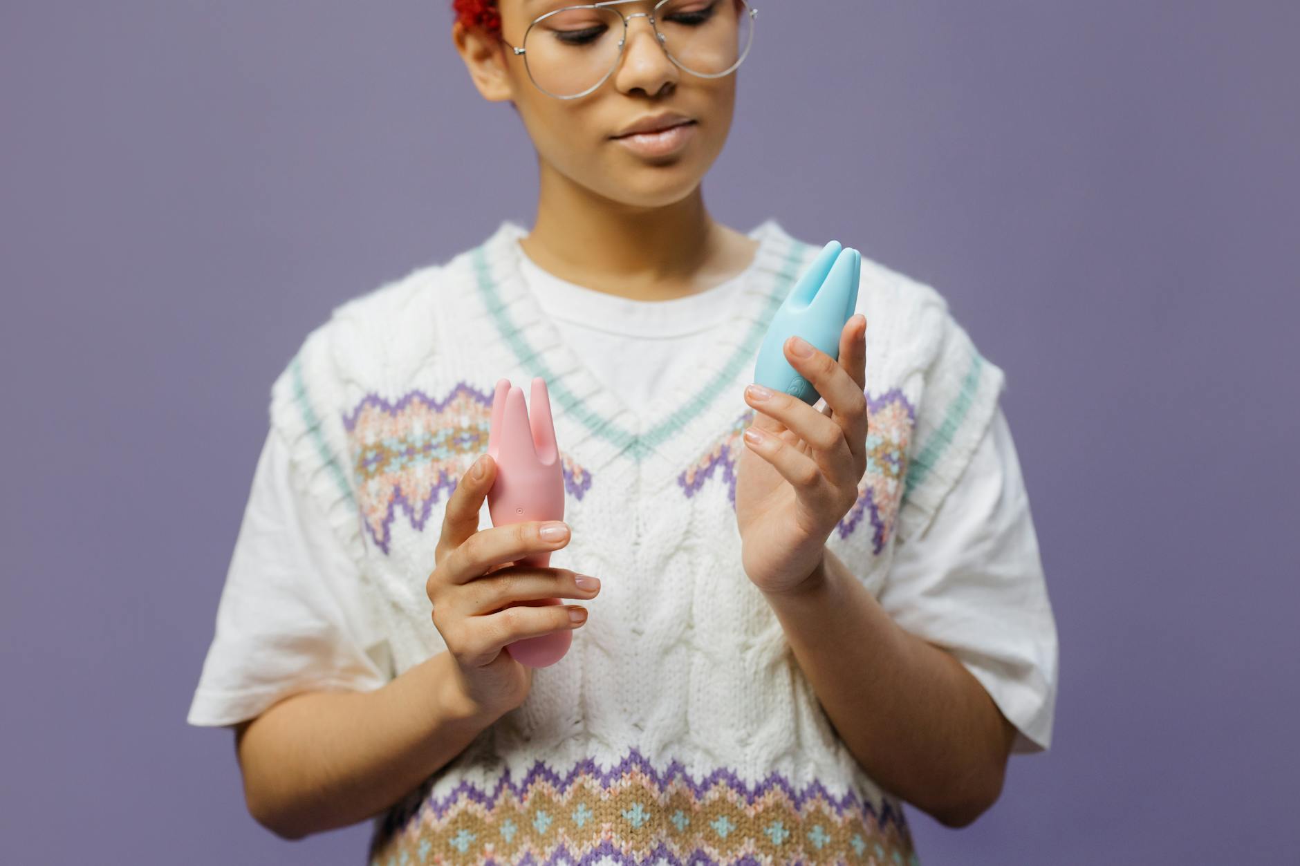 Woman holding a blue silicone vibrator, exploring solo pleasure and control