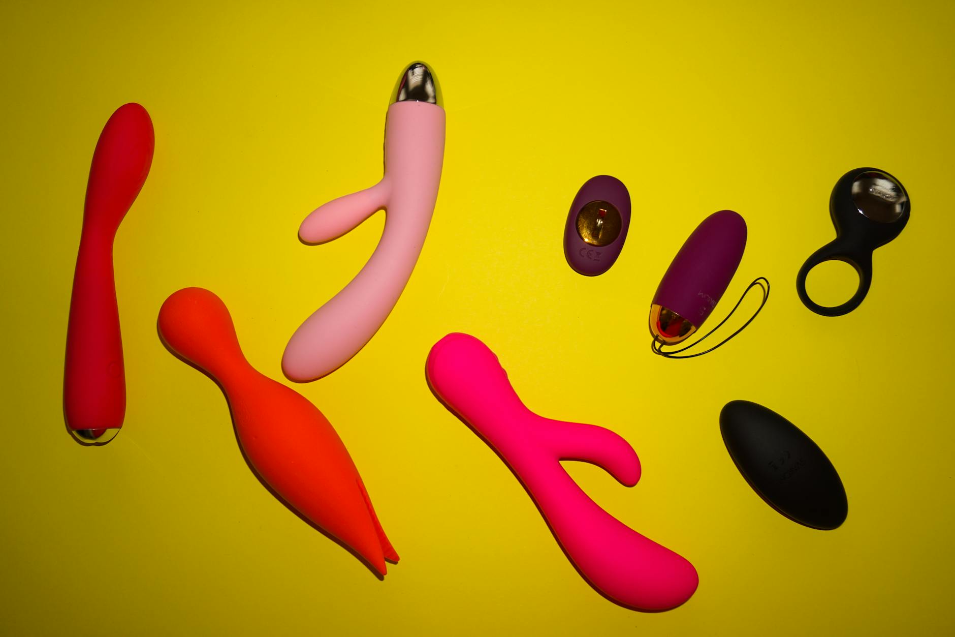 Vibrant collection of colorful lemon vibrators and sex toys arranged on a bright surface
